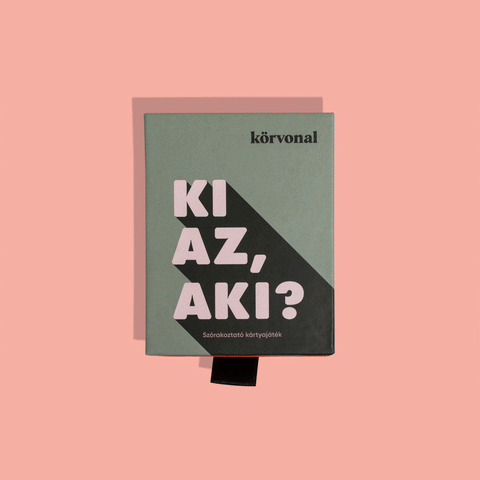 Két társasjáték csomag doboza rózsaszín háttéren, egyik dobozon „Ki az, aki?” felirat látható
